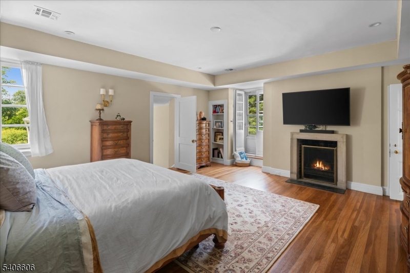 1330 Great Road Skillman, NJ 08558 - Photo 23 of 44 a spacious bedroom with a bed and a flat screen tv