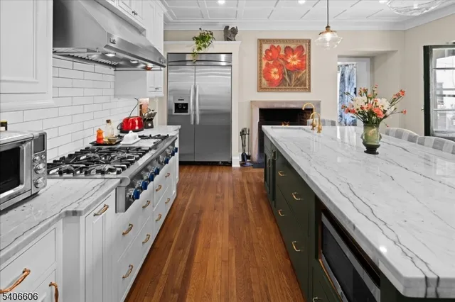 a kitchen with stainless steel appliances granite countertop a stove and a refrigerator