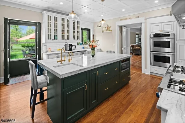 a kitchen with a table chairs refrigerator and cabinets