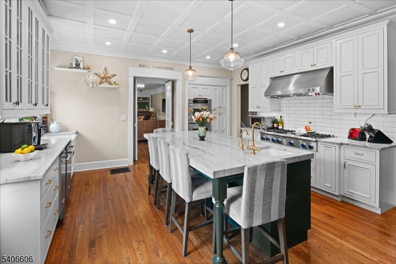 1330 Great Road Skillman, NJ 08558 - Photo 31 of 44 a kitchen with a dining table chairs wooden floor and appliances
