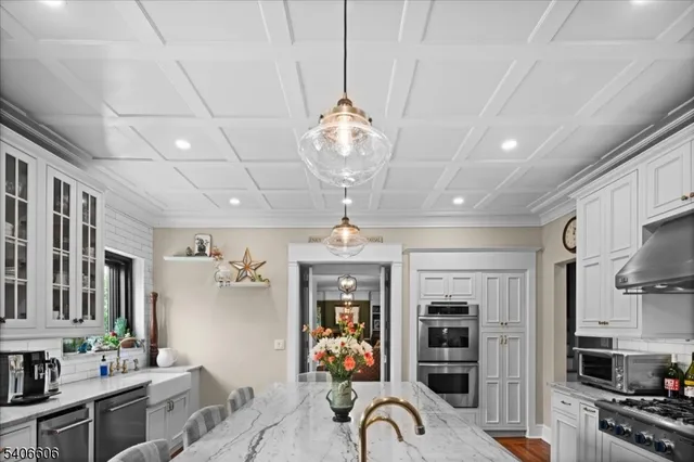 a view of a livingroom with furniture cabinet flat screen tv and windows