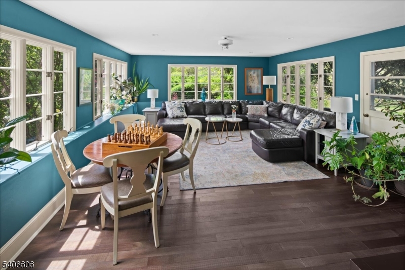 1330 Great Road Skillman, NJ 08558 - Photo 36 of 44 a living room with furniture potted plant floor to ceiling windows and a flat screen tv