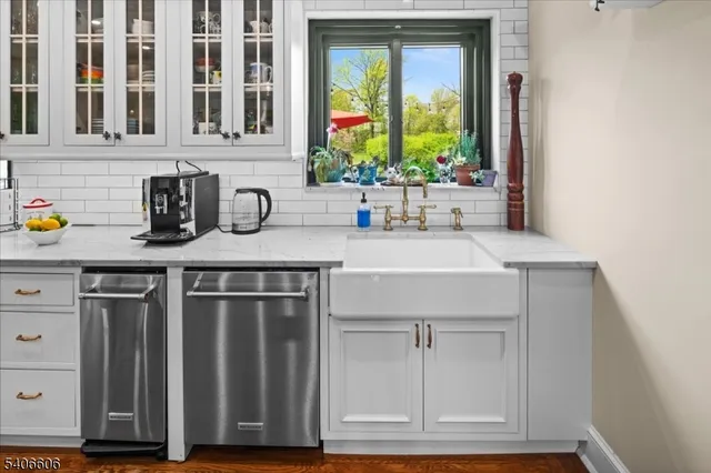 a kitchen with stainless steel appliances granite countertop a sink and a wooden cabinets