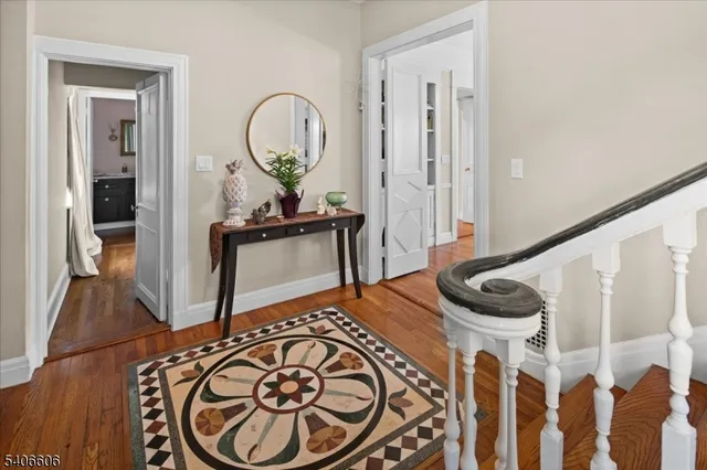 a view of a livingroom with wooden floor and a sink
