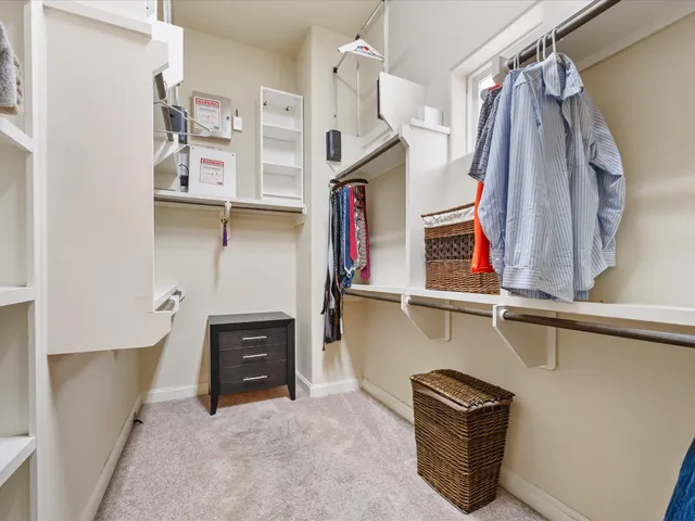 a view of a street with potted plants