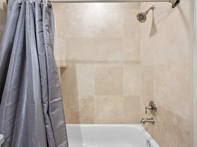 a view of a hallway with workspace and a window