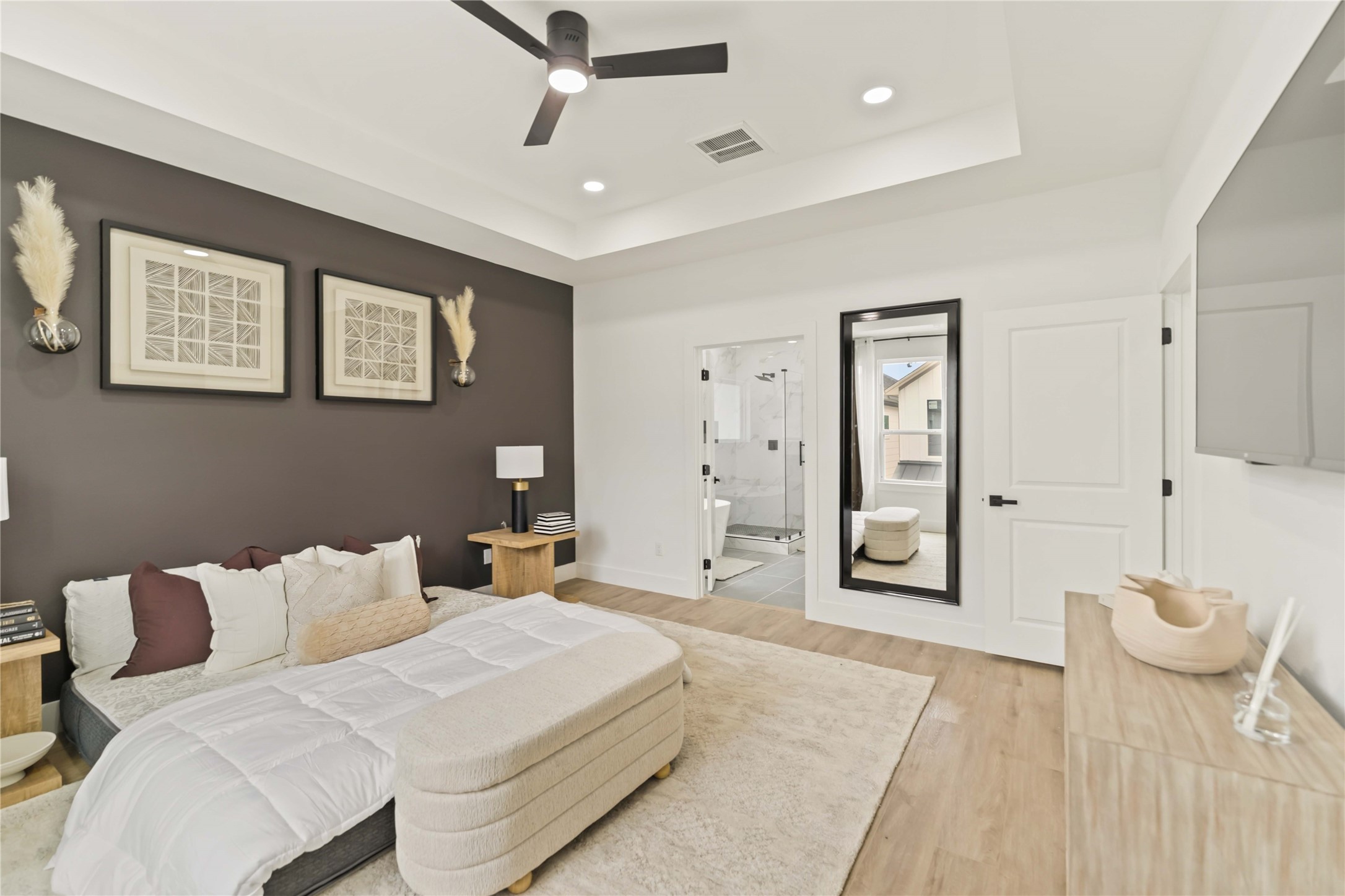 6539 Sealey Street Houston, TX 77091 - Photo 17 of 28 a spacious bedroom with a bed and a chandelier
