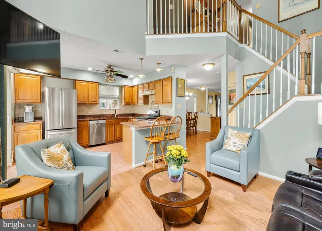 a living room with furniture and a dining table