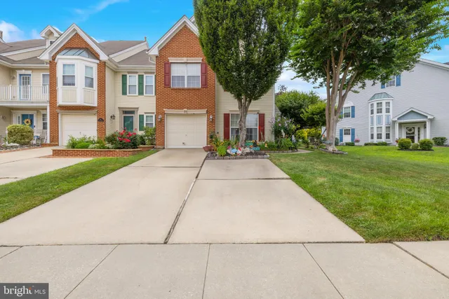 a view of a white house with a yard
