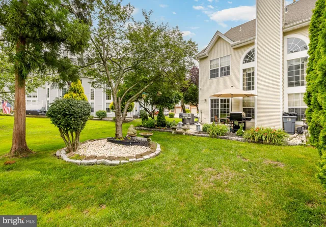 a view of a house with a backyard