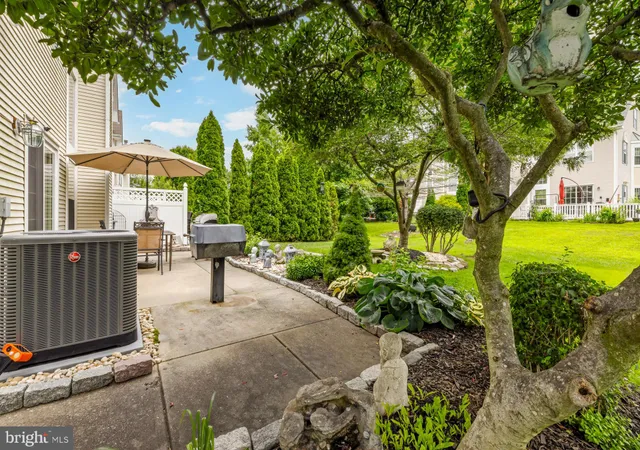 a view of a patio with a table and chairs under an umbrella
