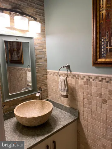 a bathroom with a sink a mirror and a window