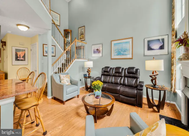 a living room with patio furniture and a painting on the wall