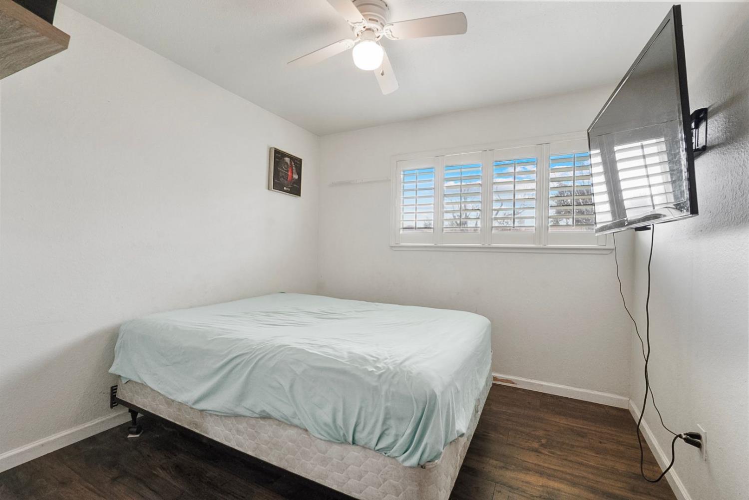 3360 Stanley Avenue Turlock, CA 95382 - Photo 11 of 17 a bedroom with a bed and a window