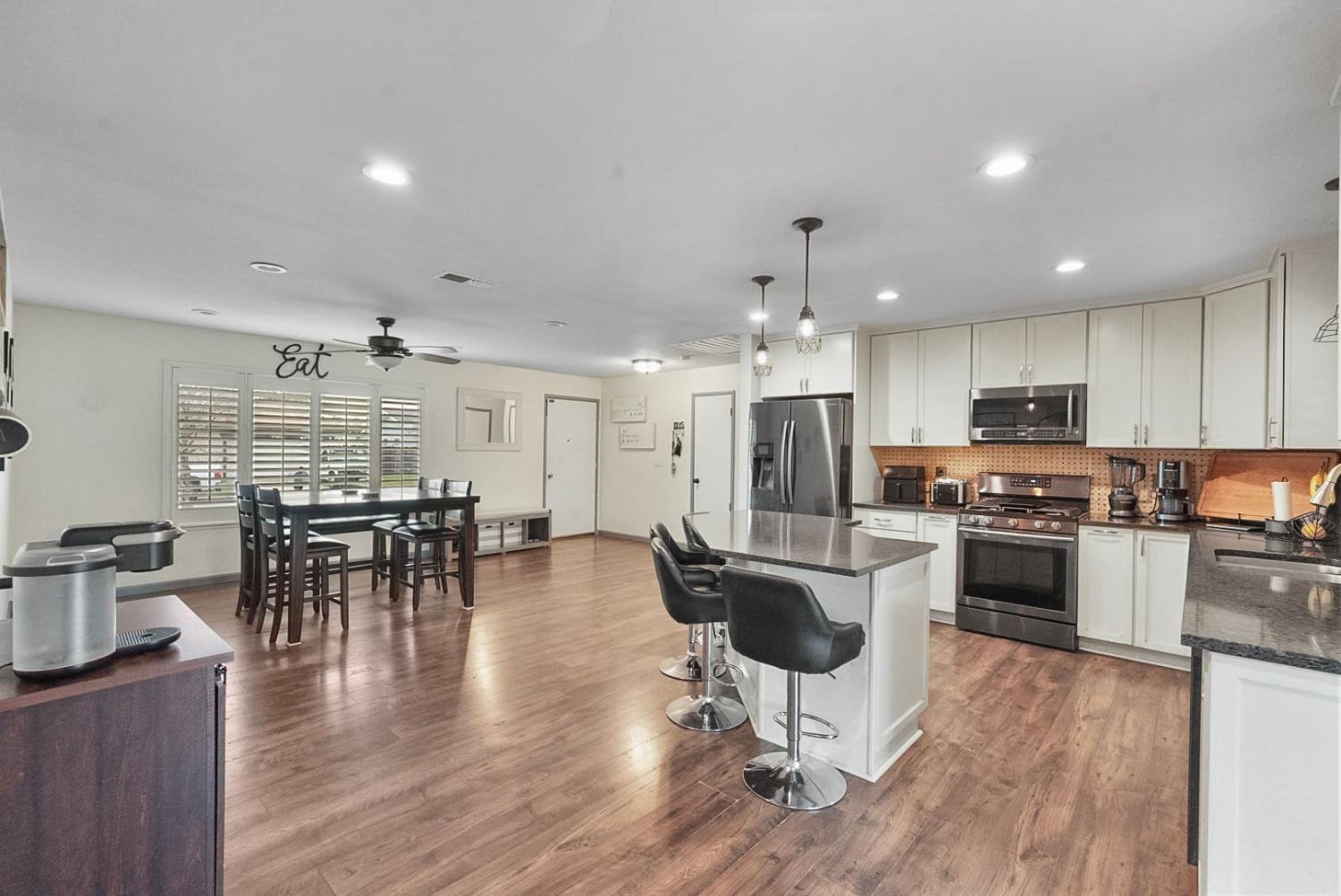 3360 Stanley Avenue Turlock, CA 95382 - Photo 6 of 17 an open kitchen with kitchen island and stainless steel appliances