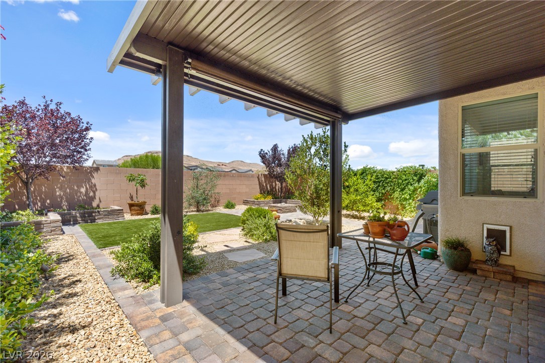 891 Earth Luster Road Las Vegas, NV 89178 - Photo 31 of 48 A spacious covered patio provides a delightful outdoor living space with views of the cultivated yard.