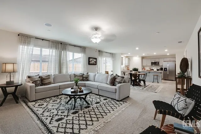 a living room with furniture dining area and a large window