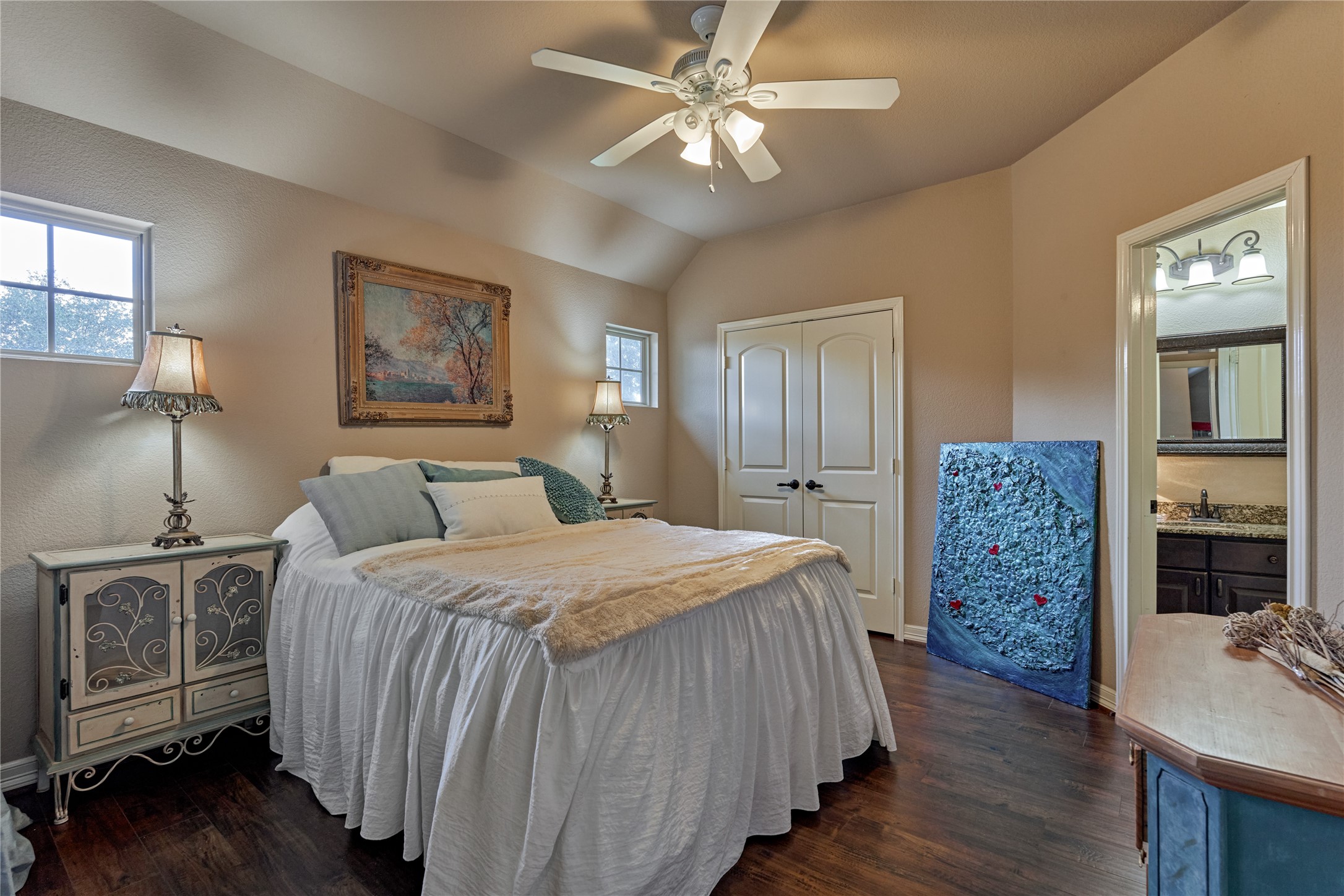 19089 Grandview Point Montgomery, TX 77356 - Photo 37 of 48 a spacious bedroom with a bed a dresser and wooden floor