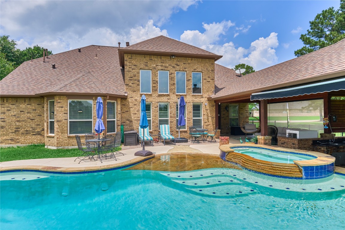 19089 Grandview Point Montgomery, TX 77356 - Photo 4 of 48 a view of a house with swimming pool and a yard