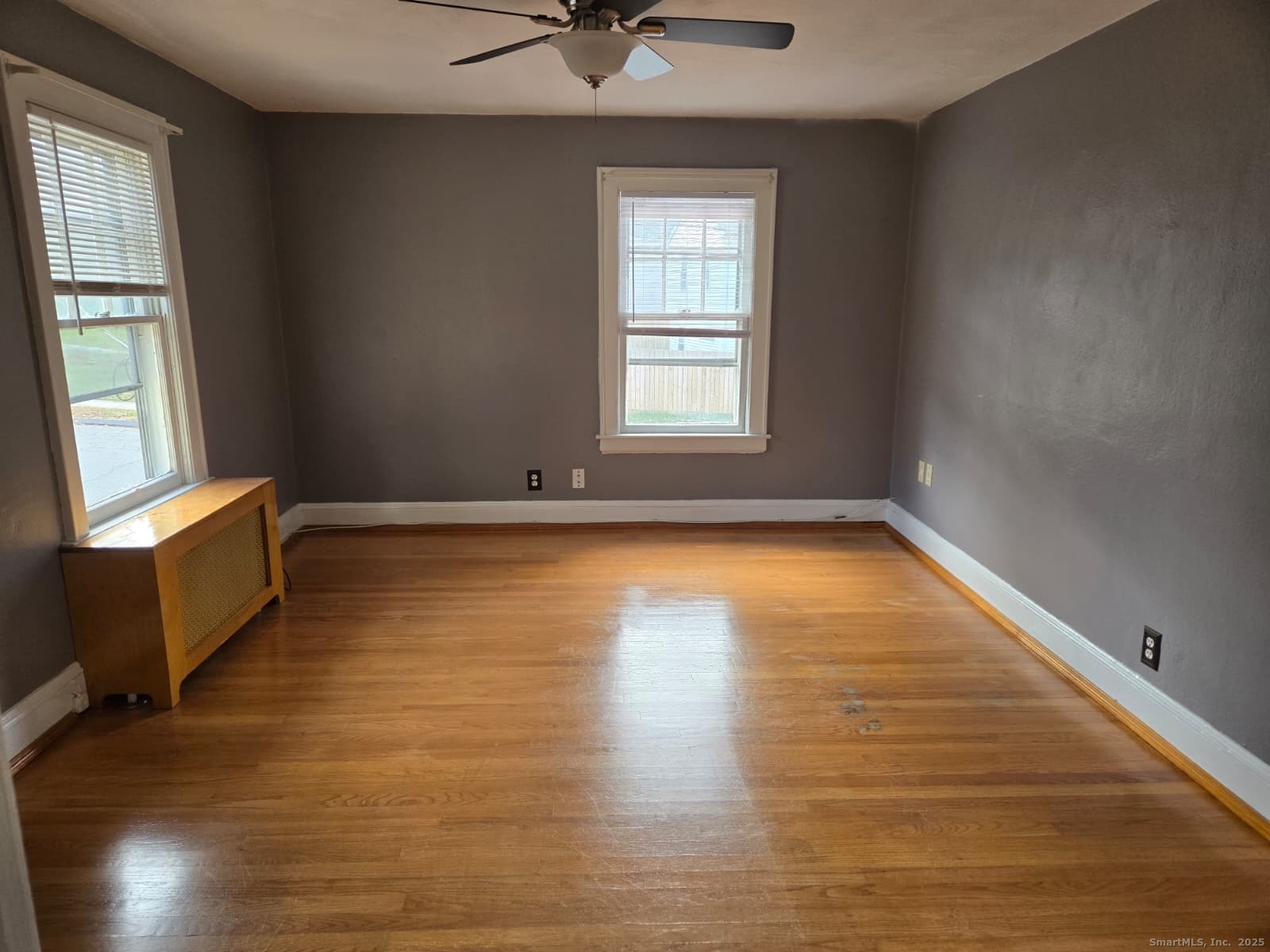 116 Hillside Avenue Middletown, CT 06457 - Photo 4 of 9 an empty room with wooden floor and windows