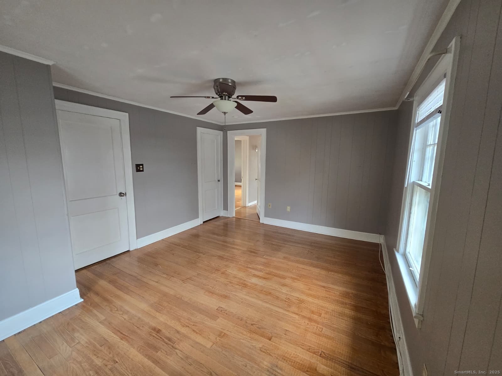 116 Hillside Avenue Middletown, CT 06457 - Photo 7 of 9 a view of empty room with wooden floor and fan