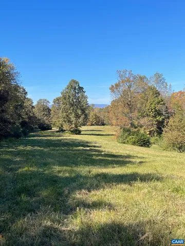 a view of a green field with clear sky