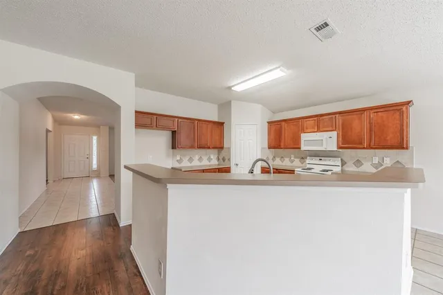 a kitchen with stainless steel appliances a sink and a refrigerator