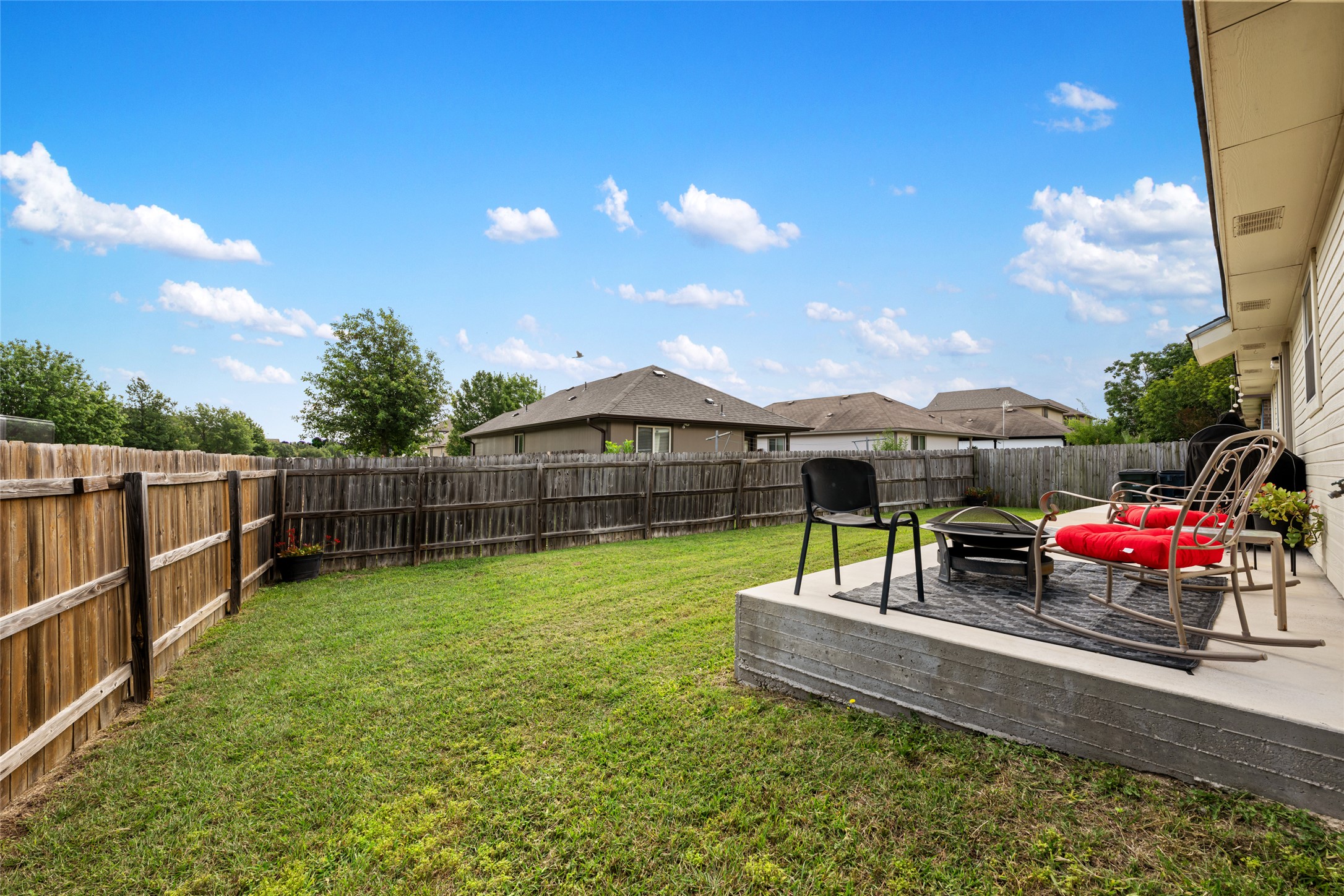 144 Calcite Lane Jarrell, TX 76537 - Photo 32 of 38 A fenced backyard offers a concrete patio, ideal for outdoor gatherings.