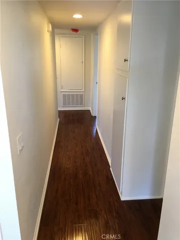 a view of a hallway and wooden floor