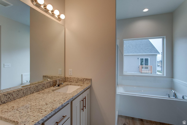 1512 West 600 North, Unit O4A Mapleton, UT 84664 - Photo 15 of 24 Full bathroom with vanity, a garden tub, and light wood-style floors
