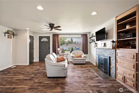 a living room with fireplace furniture and a flat screen tv