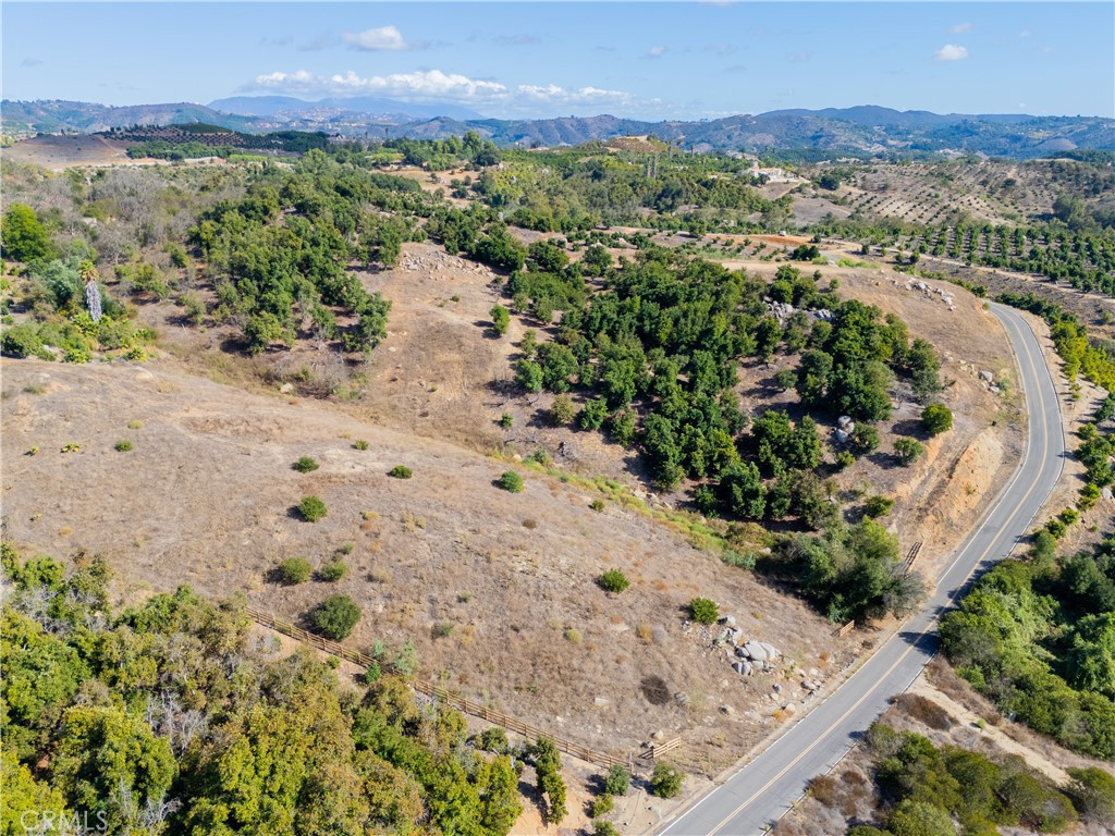 23476 La Vella Road Temecula, CA 92590 - Photo 4 of 29 an aerial view of a house with a yard and mountain view in back