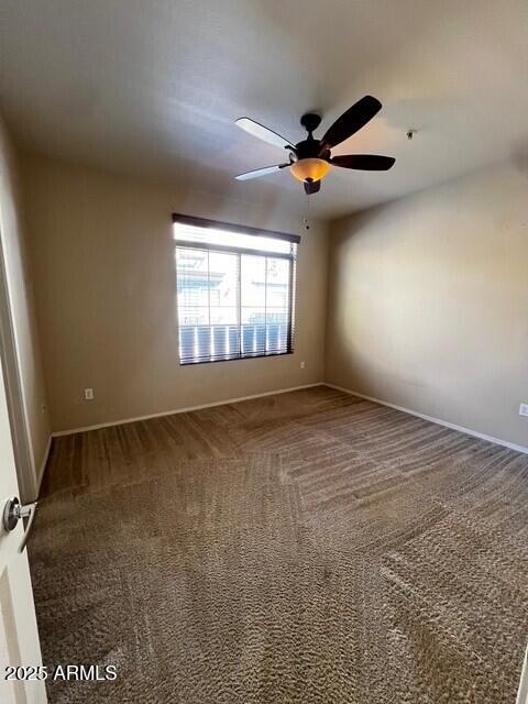 16825 North 14th Street, Unit 49 Phoenix, AZ 85022 - Photo 8 of 21 en empty room with windows and ceiling fan