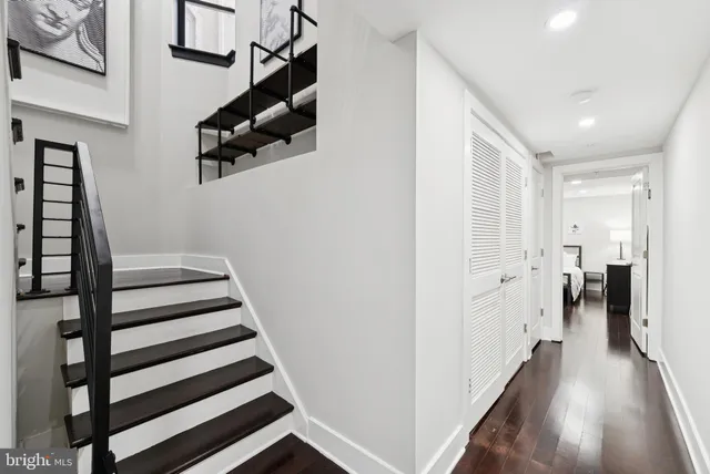a view of hallway with stairs and wooden floor