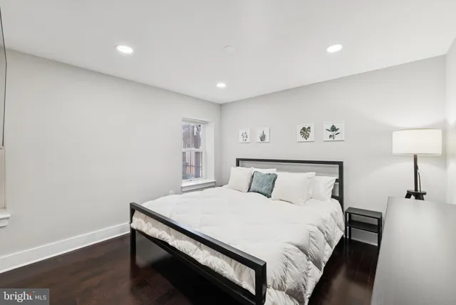 a large bed sitting in a bedroom next to a lamp