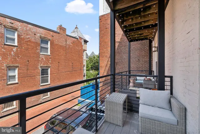 a view of balcony with two chairs and a potted plant