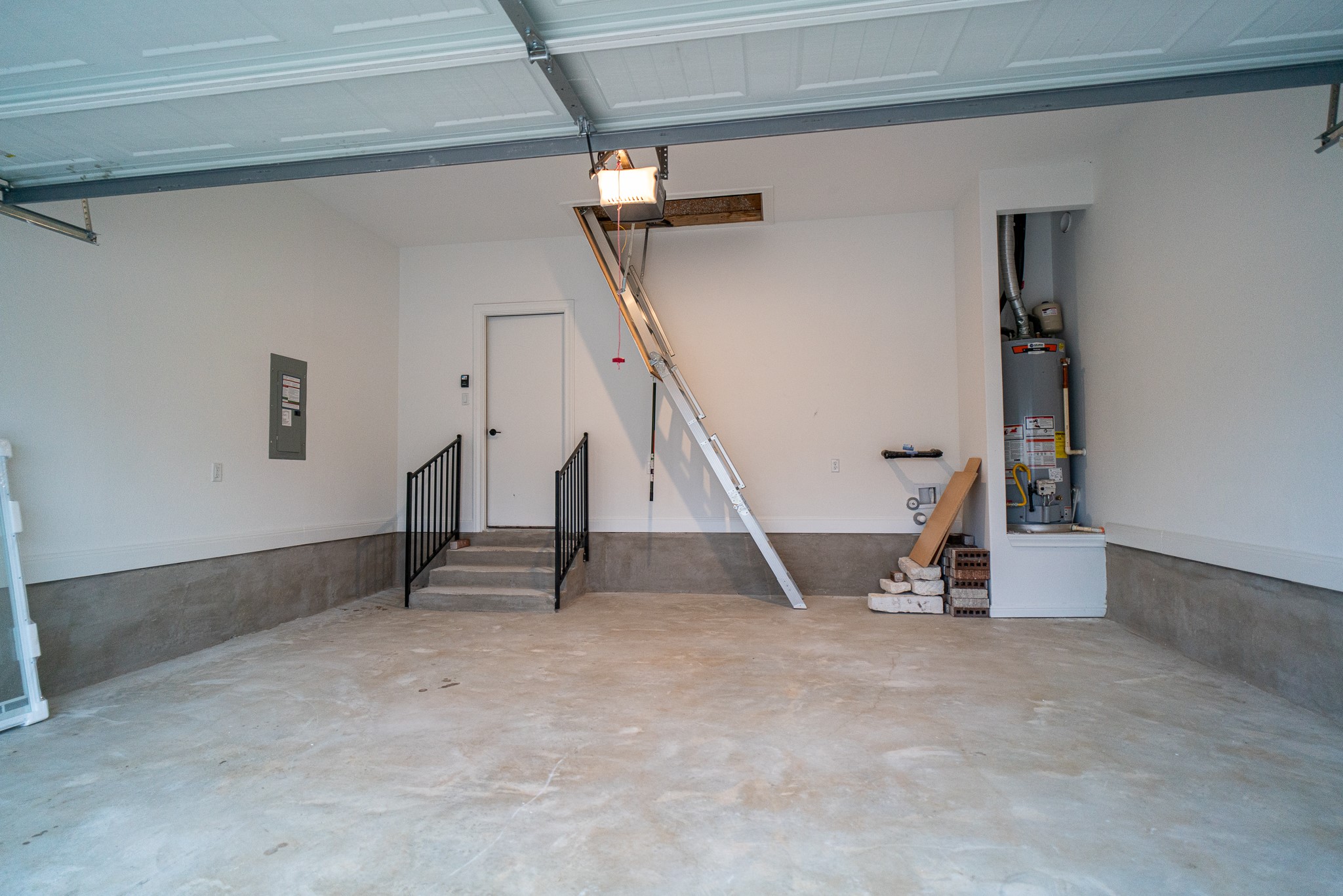 3501 Jaulan Street Leander, TX 78641 - Photo 29 of 33 Garage with gas water heater, electric panel, and a garage door opener