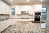 3501 Jaulan Street Leander, TX 78641 - Photo 5 of 22 a kitchen with stainless steel appliances granite countertop a stove and a refrigerator