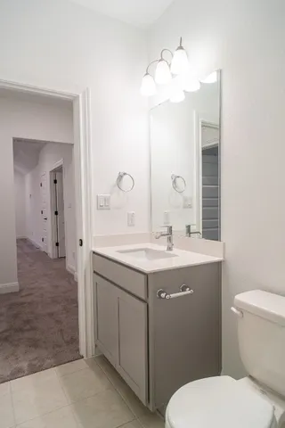 a bathroom with a toilet a sink and mirror