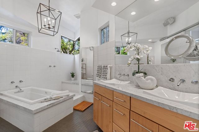 a bathroom with a granite countertop sink a toilet and mirror