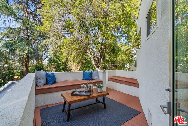 a outdoor sitting area with chairs and a table