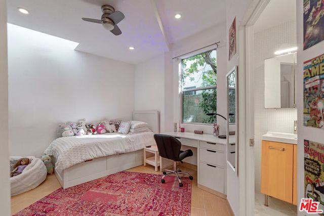 a bedroom with furniture and a window