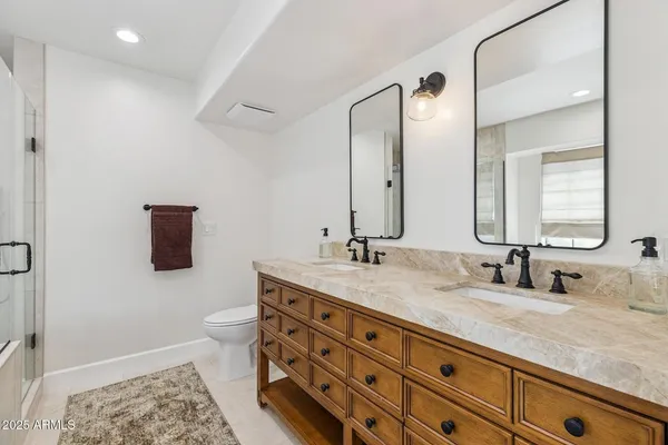 a bathroom with a double vanity sink and a mirror