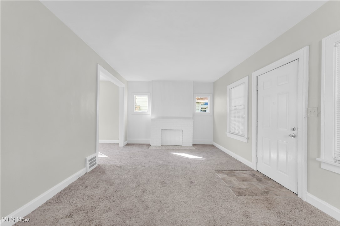 945 Nela View Road Cleveland Heights, OH 44112 - Photo 6 of 27 Unfurnished living room featuring baseboards and carpet flooring