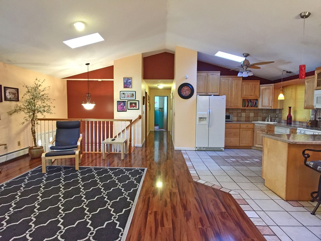 353 Renaud Street Fall River, MA 02721 - Photo 11 of 21 a kitchen with a wooden floor and a refrigerator