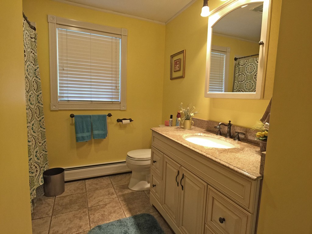 353 Renaud Street Fall River, MA 02721 - Photo 13 of 21 a bathroom with a granite countertop sink toilet and a mirror