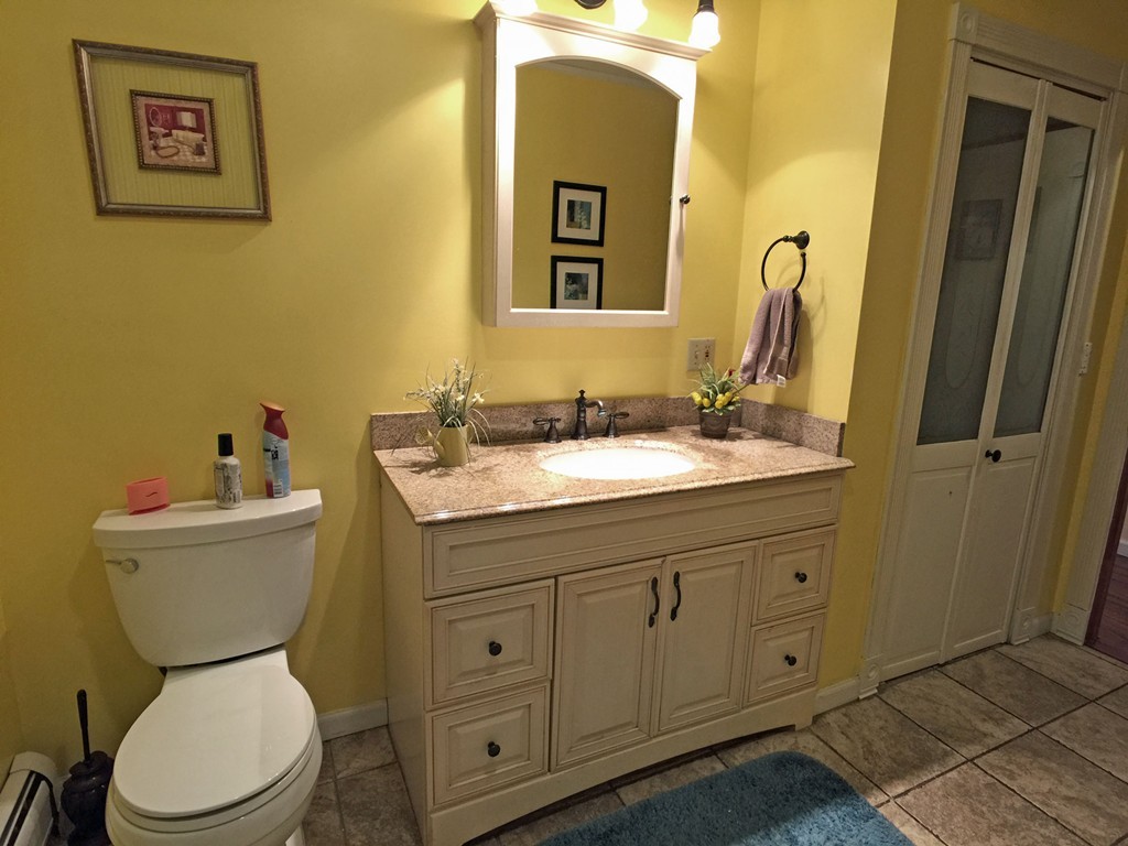 353 Renaud Street Fall River, MA 02721 - Photo 15 of 21 a bathroom with a toilet sink and mirror