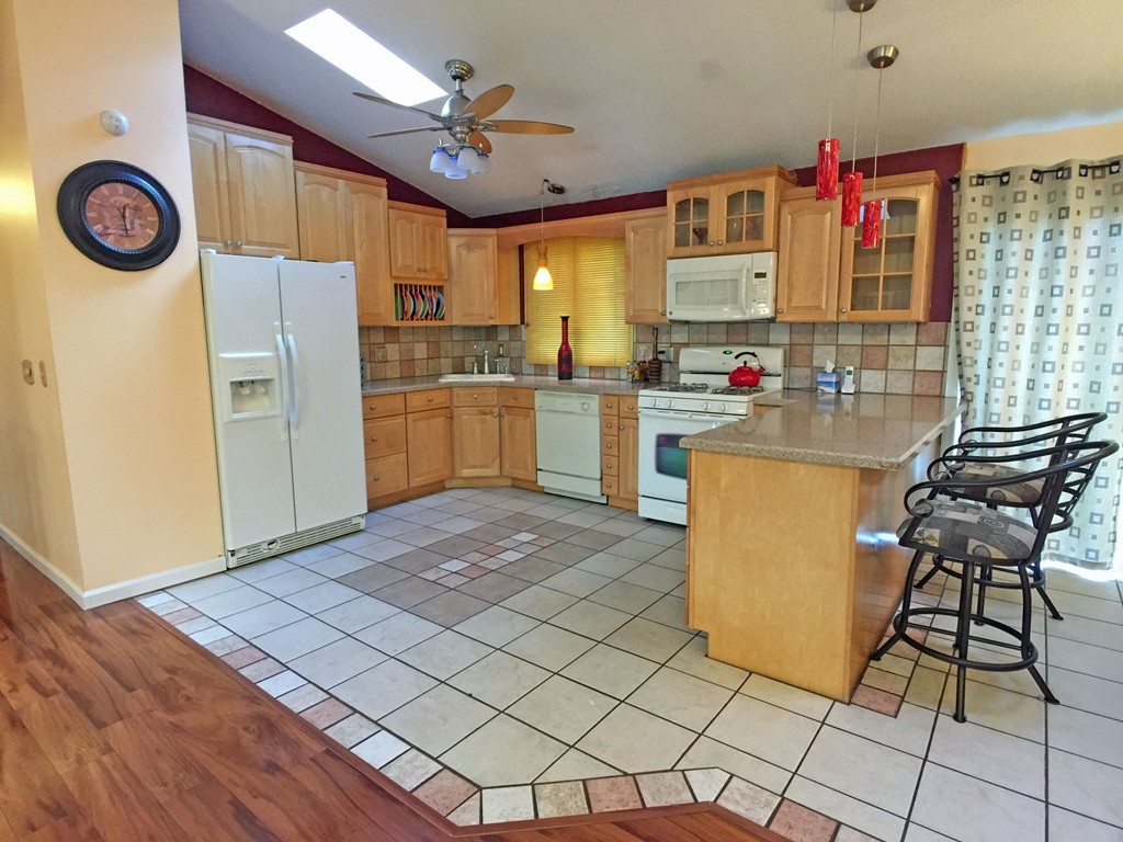 353 Renaud Street Fall River, MA 02721 - Photo 7 of 21 a kitchen with a refrigerator and a stove top oven