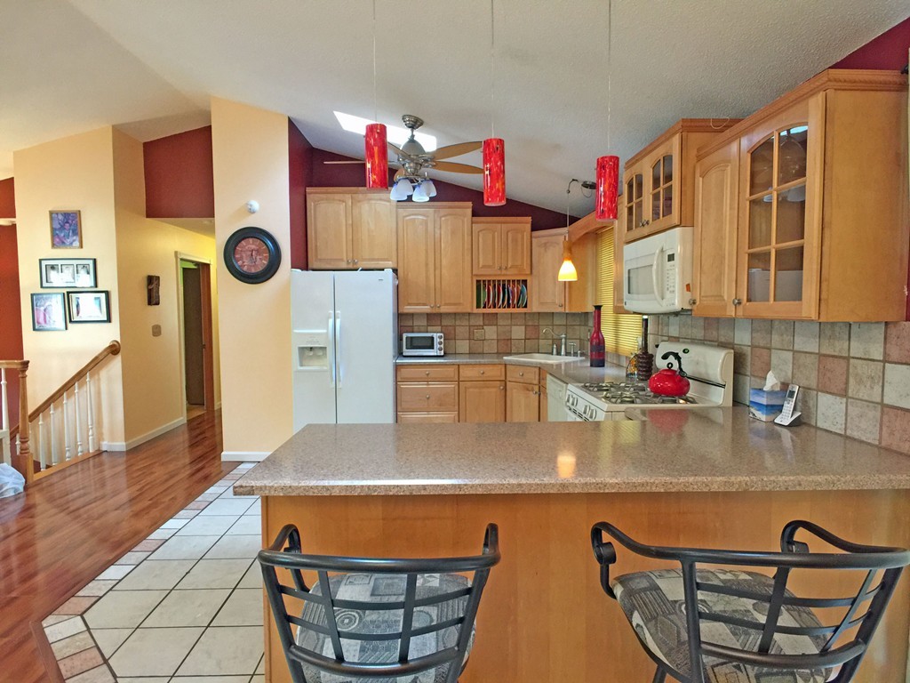 353 Renaud Street Fall River, MA 02721 - Photo 8 of 21 a kitchen with stainless steel appliances granite countertop a sink and a microwave