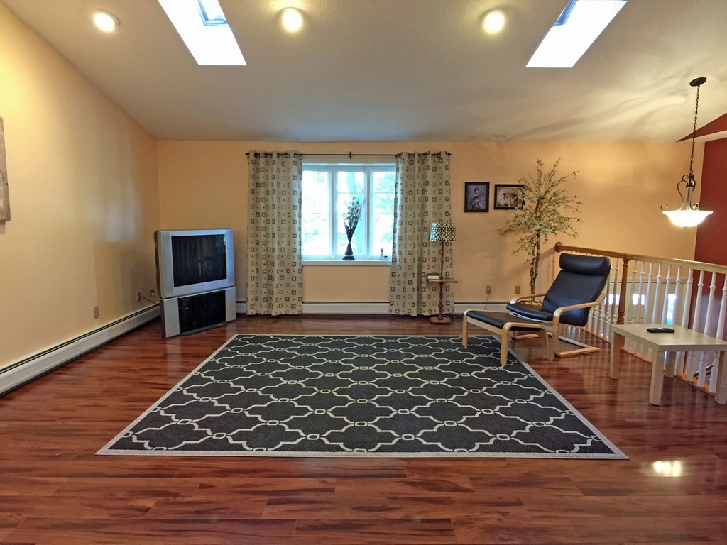 353 Renaud Street Fall River, MA 02721 - Photo 10 of 21 a living room with furniture rug and wooden floor